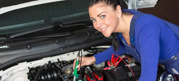 woman repairing car