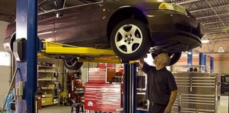 man repairing car